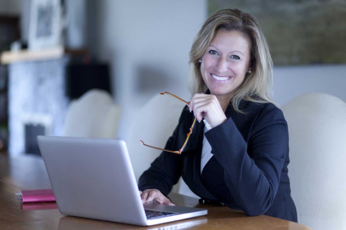 Proud Businesswoman At Home Office Using Laptop