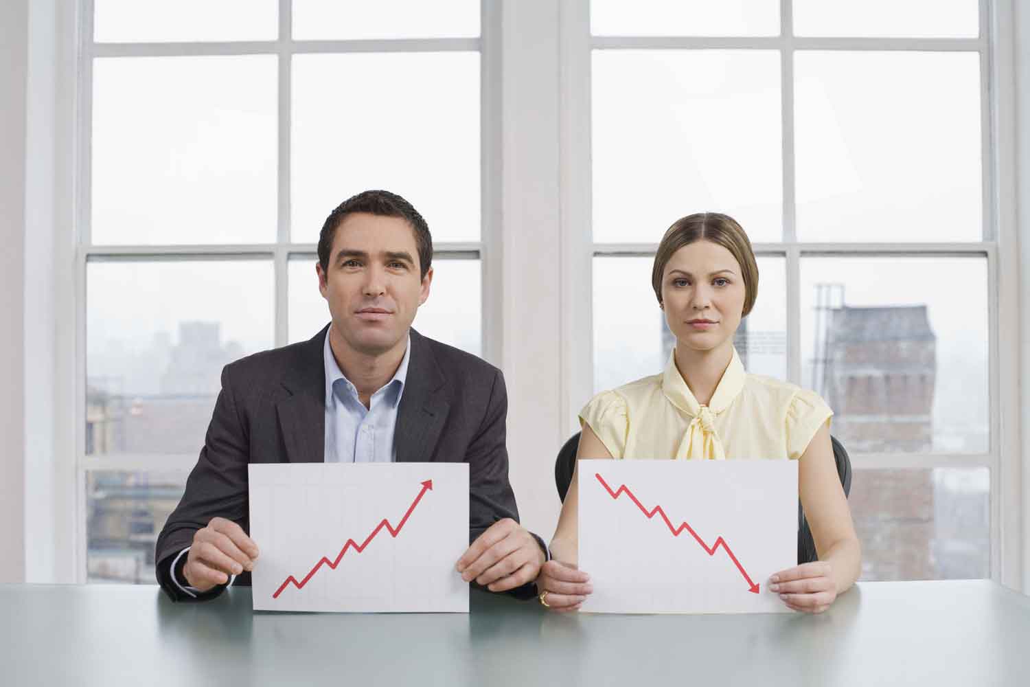 Two business coworkers holding charts
